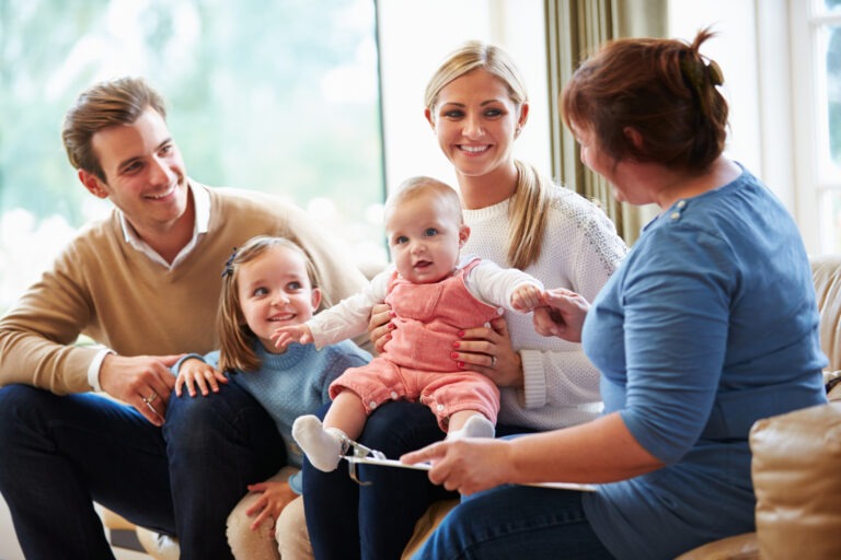 Health Visitor Talking To Family With Young Baby